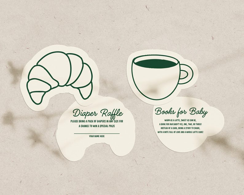 May include: Four cream-colored paper cutouts with dark green outlines. One is a croissant, another a coffee cup, and two with text. The text reads "Diaper Raffle" and "Books for Baby". The diaper raffle cutout has a space for a name.