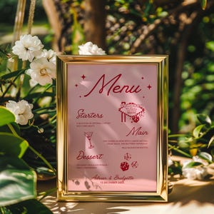 May include: A gold-framed menu sign with a pink background and red text. The menu lists "Starters", "Main", and "Dessert" with a few food items listed under each category. The sign also includes a graphic of the Las Vegas sign and dice. The text at the bottom of the sign reads "Adrian & Bridgette 15 December 20XX".