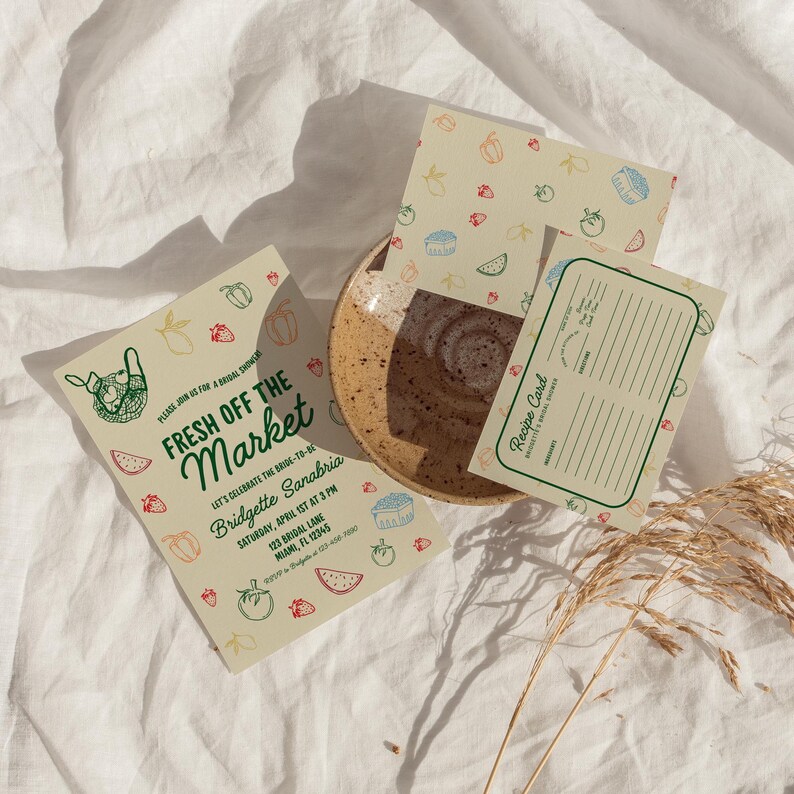 May include: A green and white invitation card with a hand-drawn illustration of a basket of produce. The text reads "Fresh Off The Market" and includes details for a bridal shower. A recipe card with a similar design is also included.