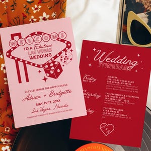 May include: A pink and red welcome card with a Las Vegas casino sign graphic. The card says "Welcome to a Fabulous Las Vegas Wedding" and includes the names Adrian and Bridgette. A red card with white text says "Wedding Itinerary" and lists the dates and times for the wedding events.