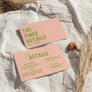 May include: Pink wedding invitation cards with green text. The top card says "The Finer Details" and the bottom card says "Here Are The Details" with information about accommodations, attire, wedding registration, and more info.