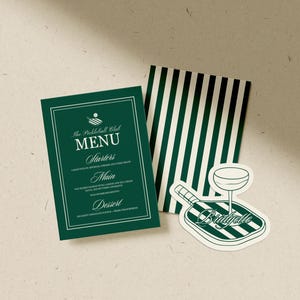 May include: A dark green menu card with white text and a white border. The menu is for "The Pickleball Club" and lists starters, main, and dessert options. A sticker with a pickleball paddle and a cocktail glass is also present.