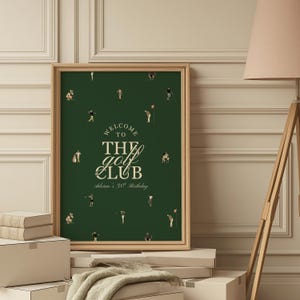 May include: A framed poster with a dark green background and a golf theme. The poster features small illustrations of golfers and the text "WELCOME TO THE golf CLUB" in white and gold. The text "Adrian's 30th Birthday" is below the main text.