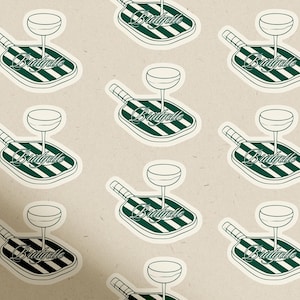 May include: A repeating pattern of stickers featuring a cocktail glass atop a green and white striped paddle. The word "Bridgelle" is written in cursive on the paddle. The background is a light beige color.