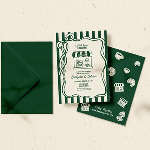 May include: A baby shower invitation suite featuring a green envelope, a card with a coffee shop illustration, and a matching card with coffee-themed stickers. The invitation reads "A little bean is brewing!" and includes event details.