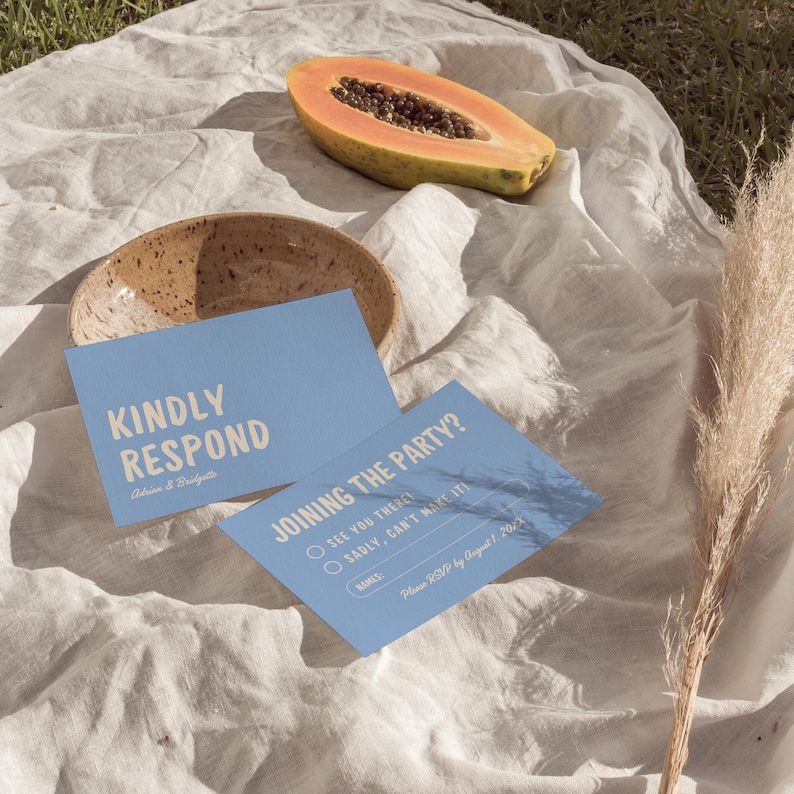 May include: Blue RSVP cards with white text. The top card says "Kindly Respond" and the bottom card says "Joining the Party?" with options to RSVP "See you there!" or "Sadly, can't make it!" and a space to write names. Please RSVP by August 1, 2023.