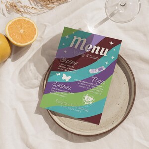 Peut inclure: Une carte de menu colorée avec un design fantaisiste mettant en vedette un papillon et des étoiles. Le menu comprend des "Entrées", "Plat principal" et "Dessert" avec quelques plats listés sous chaque catégorie. Le texte en haut de la carte indique "Menu 30. flirty & thriving" et le bas de la carte indique "Bridgette's 30th Birthday 3 October 20XX".
