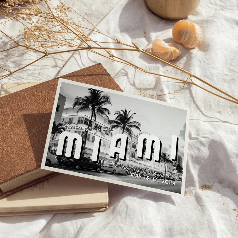 May include: Black and white postcard with a photo of palm trees and buildings in Miami, Florida. The text on the postcard reads "We're going to Miami!" and "Bridget's Bachelorette May 15-17, 20XX".