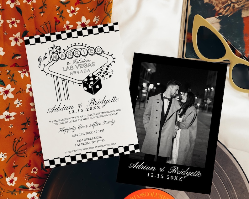 May include: Black and white wedding invitation with a Vegas theme. The invitation features a stylized illustration of the "Welcome to Fabulous Las Vegas" sign with dice and the text "Just Married". The invitation also includes the couple's names, wedding date, and details about the reception. A black and white photo of the couple is included on the right side of the invitation.