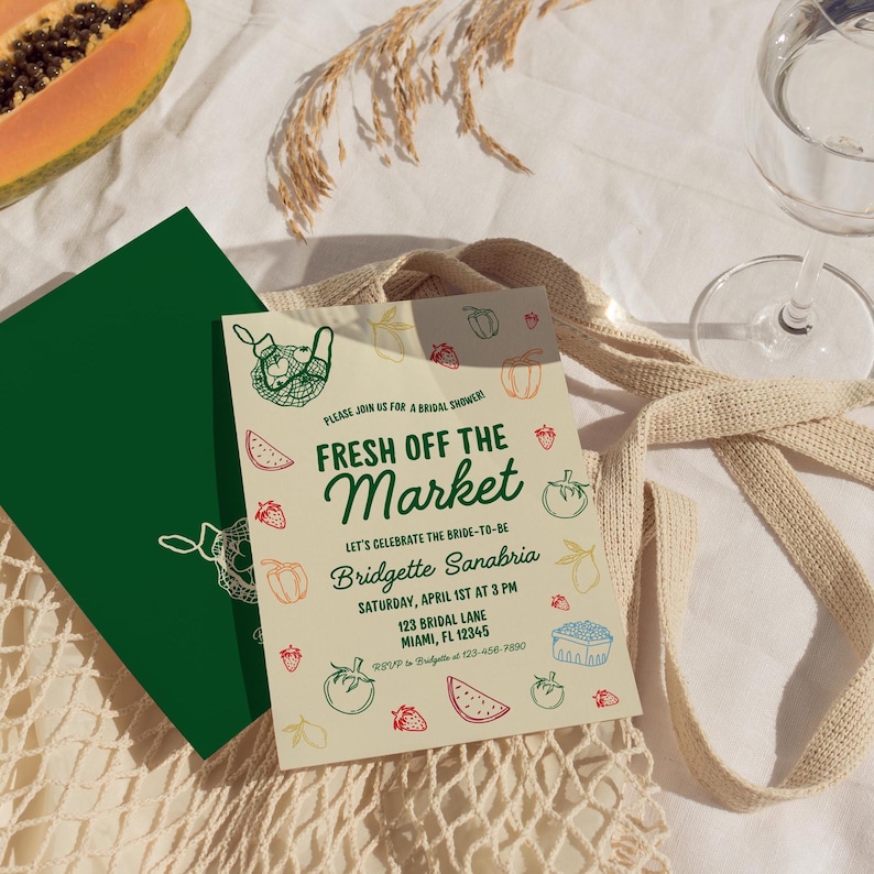May include: A light yellow bridal shower invitation with green, red, and blue illustrations of fruits and vegetables. The text reads "Fresh Off The Market" and includes the bride-to-be's name, date, time, and location.