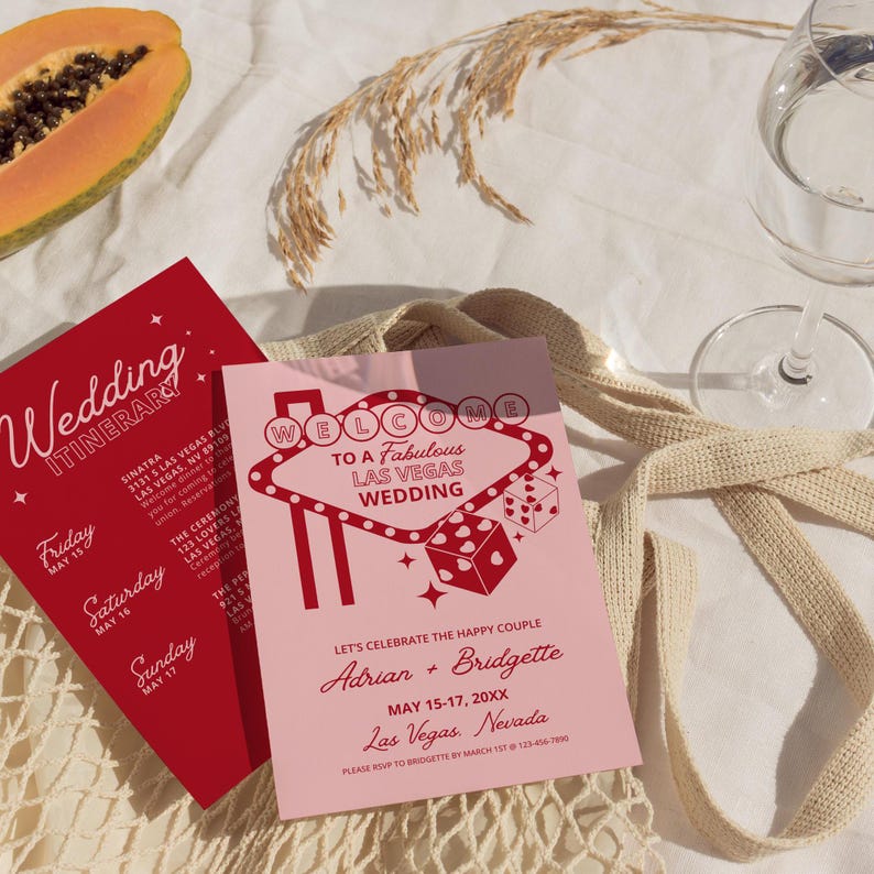 May include: A pink and red wedding invitation with a Las Vegas theme. The invitation features a stylized illustration of the iconic "Welcome to Fabulous Las Vegas" sign with dice and stars. The text reads "Let's celebrate the happy couple Adrian + Bridgette May 15-17, 20XX Las Vegas, Nevada Please RSVP to Bridgette by March 1st 123-456-7890"