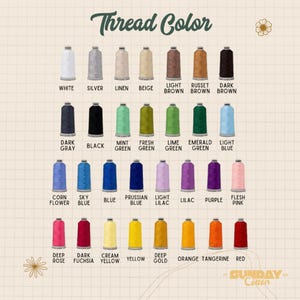 May include: A color chart displaying twenty-eight spools of embroidery thread arranged in four rows. Each spool is labeled with its corresponding color name, including white, silver, linen, beige, brown shades, various greens, blues, purples, pinks, and warm tones.