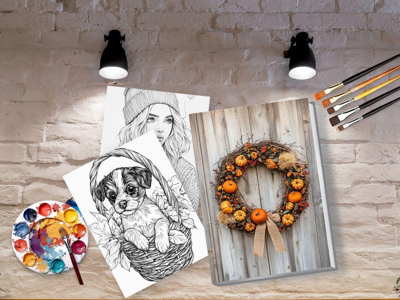 May include: Three black and white coloring pages featuring a woman with a beanie, a puppy in a basket, and a wreath with pumpkins. A paint palette with watercolor paints and paintbrushes are also included.