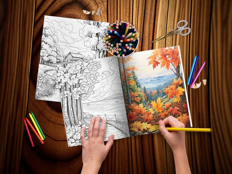 May include: A person coloring in a coloring book with a yellow pencil. The coloring book has two pages open, one with a black and white drawing of a house and trees by a lake, and the other with a colored drawing of a forest with fall foliage.