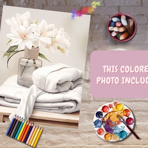 May include: A painting of white flowers in a vase on a table with a stack of white towels. The painting is surrounded by a brick wall with a paint palette, colored pencils, and a container of colored chalk.