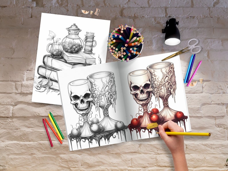 May include: A coloring book page featuring two skull-shaped goblets with dripping red liquid and red apples. The goblets are surrounded by vines and leaves. The page is open to reveal the coloring book's interior.