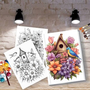 May include: Three blank canvases with a birdhouse and flowers drawn in black and white and one canvas with a birdhouse and flowers painted in color. The canvases are on a wooden surface with a paint palette and brushes.
