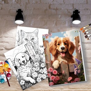 May include: A collection of dog and cat-themed art prints. One print features a colorful dog behind a wooden fence surrounded by pink flowers. Two black and white coloring book style prints show a cat and a dog.