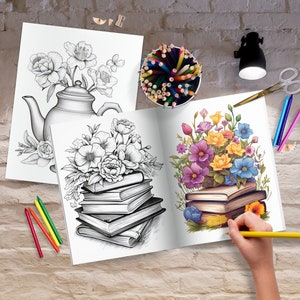 May include: An open adult coloring book with a floral design is being colored with a yellow pencil. A black and white floral design coloring book and a pencil holder with colored pencils are also visible. Scissors and crayons are on the table.
