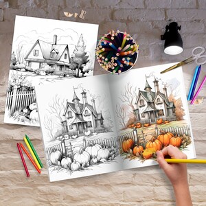 May include: An open coloring book with a black and white illustration of a house with a fence and pumpkins. The right page of the book is partially colored with orange pumpkins and a brown path leading to the house.