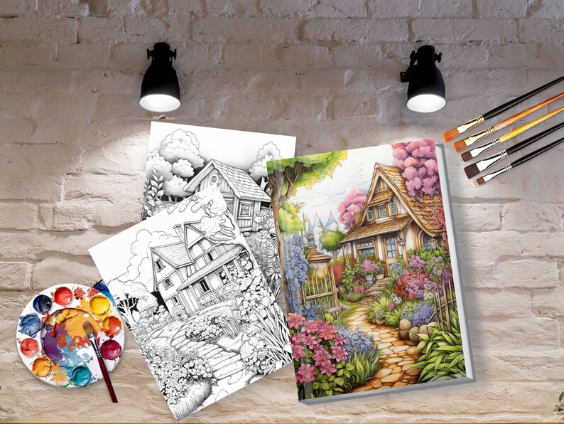May include: Two coloring book pages featuring detailed illustrations of houses with gardens. The pages are open on a table with a paint palette and brushes.
