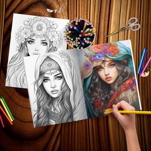 May include: An open coloring book with two black and white illustrations of women with elaborate headwear. The book is open to a page with a woman wearing a blue headscarf and a floral crown. A hand is holding a yellow pencil over the page.