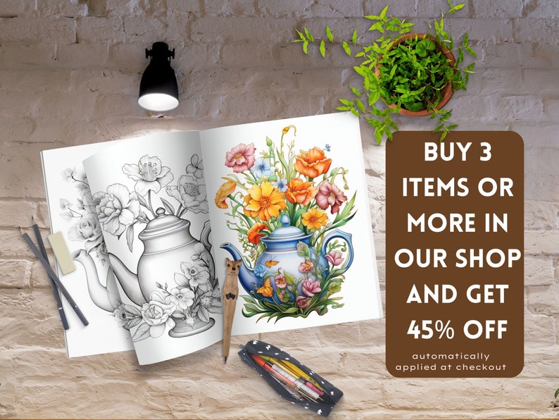 May include: An open adult coloring book with a floral teapot design, featuring a black and white illustration on one page and a colored version on the other. A wooden pen and colored pencils are next to the book. Text on a brown sign says "BUY 3 ITEMS OR MORE IN OUR SHOP AND GET 45% OFF".