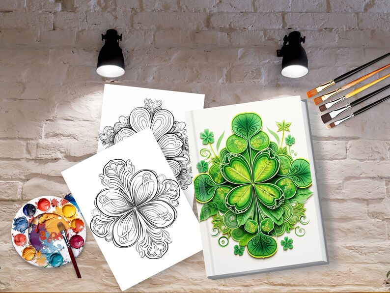 May include: A white book with a detailed green shamrock design, along with two black and white shamrock coloring pages. A watercolor palette and paintbrushes are also visible, suggesting an art or craft theme.
