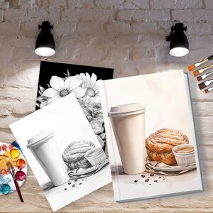 May include: Two illustrations of a coffee cup and pastry on white paper. The illustration on the left is in pencil and the illustration on the right is in watercolor. The illustrations are on a table with a paint palette, paintbrushes, and a brick wall in the background.