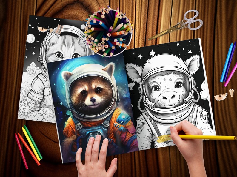 May include: Colouring books with animal astronauts. One book shows a raccoon in an orange spacesuit, another a cow, and a third a cat. A child is colouring the cow astronaut with a yellow pencil. Coloured pencils and scissors are also on the wooden surface.