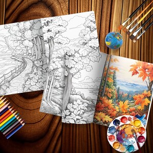 May include: A coloring book with a black and white illustration of a path through a forest and a lake. The book is open to a page with a colored illustration of a forest scene with fall foliage. The book is on a wooden table with paintbrushes, a paint palette, and colored pencils.