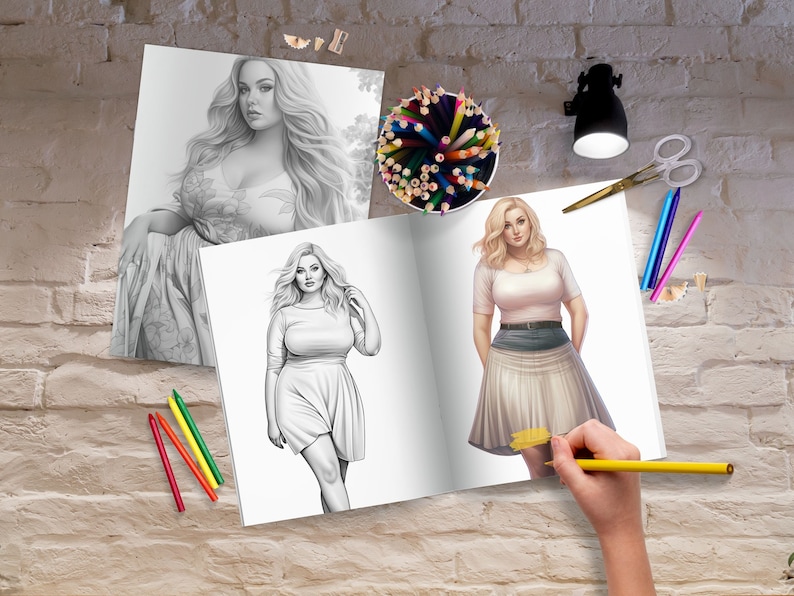 May include: An open coloring book with two black and white illustrations of women. The book is on a brick wall background with a pencil cup, pencils, and a lamp.