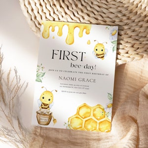 May include: A yellow and white bee-themed first birthday party invitation with a dripping honey design, two cartoon bees, a honeycomb, and the text "FIRST bee-day!" and "JOIN US TO CELEBRATE THE FIRST BIRTHDAY OF NAOMI GRACE".