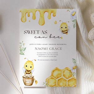 May include: A baby shower invitation with a watercolor illustration of a bee and honeycomb. The invitation reads "Sweet as can bee" and includes the name Naomi Grace.