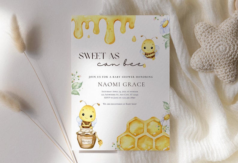 May include: A baby shower invitation with a watercolor illustration of a bee and honeycomb. The invitation reads "Sweet as can bee" and includes the name Naomi Grace.