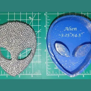 May include: A blue silicone mold for making resin crafts. The mold is shaped like an alien head with large eyes and a rounded head. The mold is approximately 3.25 inches by 4.5 inches.