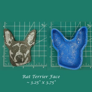 May include: A blue silicone mold of a Rat Terrier dog's face, next to a gray concrete cast of the same mold. The mold and cast are both approximately 3.25 inches by 3.75 inches.