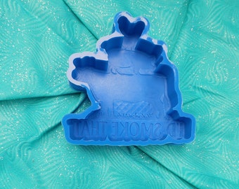 May include: Blue silicone mold shaped like a cartoon character with the text "I'd Smoke That" on the bottom.