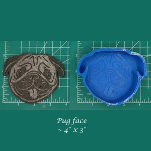 May include: A silicone mold for making pug face shaped crafts. The mold is blue and shows a pug face with a tongue sticking out. The mold is approximately 4 inches by 3 inches.