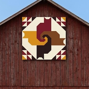 May include: A square wall art piece featuring a geometric design of four stylised cat silhouettes in burgundy, mustard yellow, brown, and dark brown, arranged in a pinwheel pattern against a cream background with corner triangle accents.