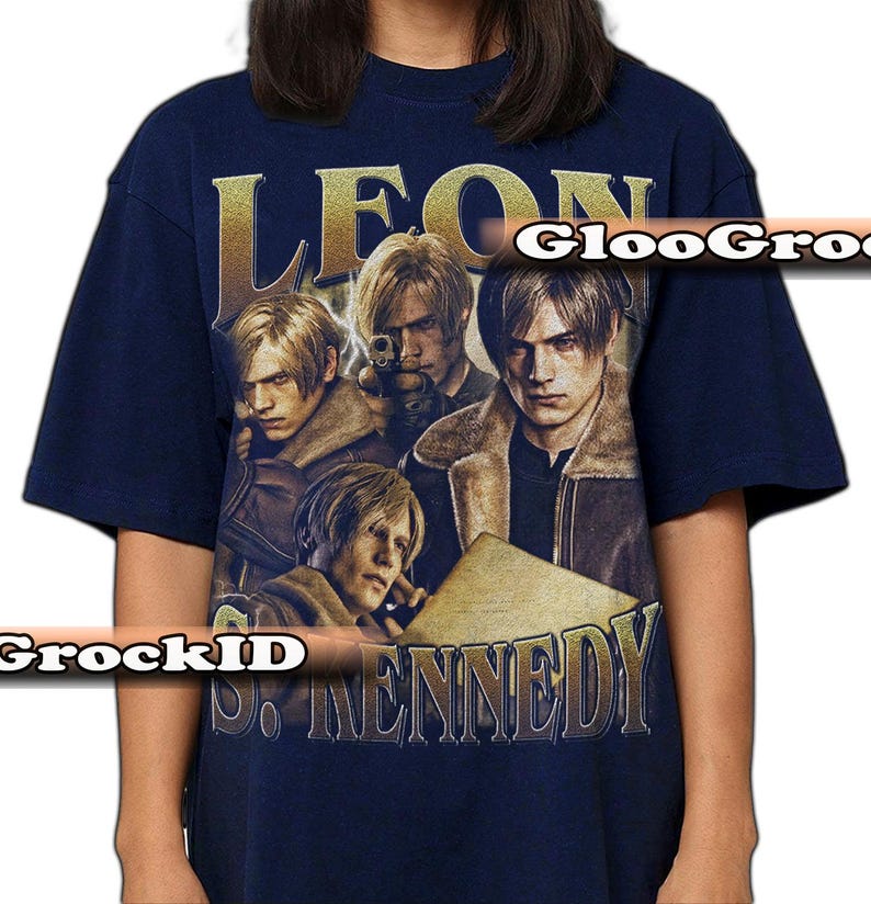 May include: A navy blue short-sleeve t-shirt featuring a graphic print of the character Leon S. Kennedy in multiple poses. The design includes the text "LEON" at the top and "S. KENNEDY" at the bottom in a metallic gold font, with a watermark overlay.