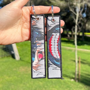 BUY 2 GET 3 - Doppelseitiger bestickter Anime Schlüsselanhänger / Jet Tag