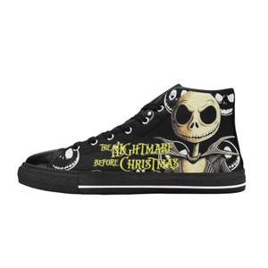 May include: Black high-top canvas sneakers featuring a design from "The Nightmare Before Christmas." The sneakers display Jack Skellington's face and the movie title in yellow. The shoes have white laces and a white sole.