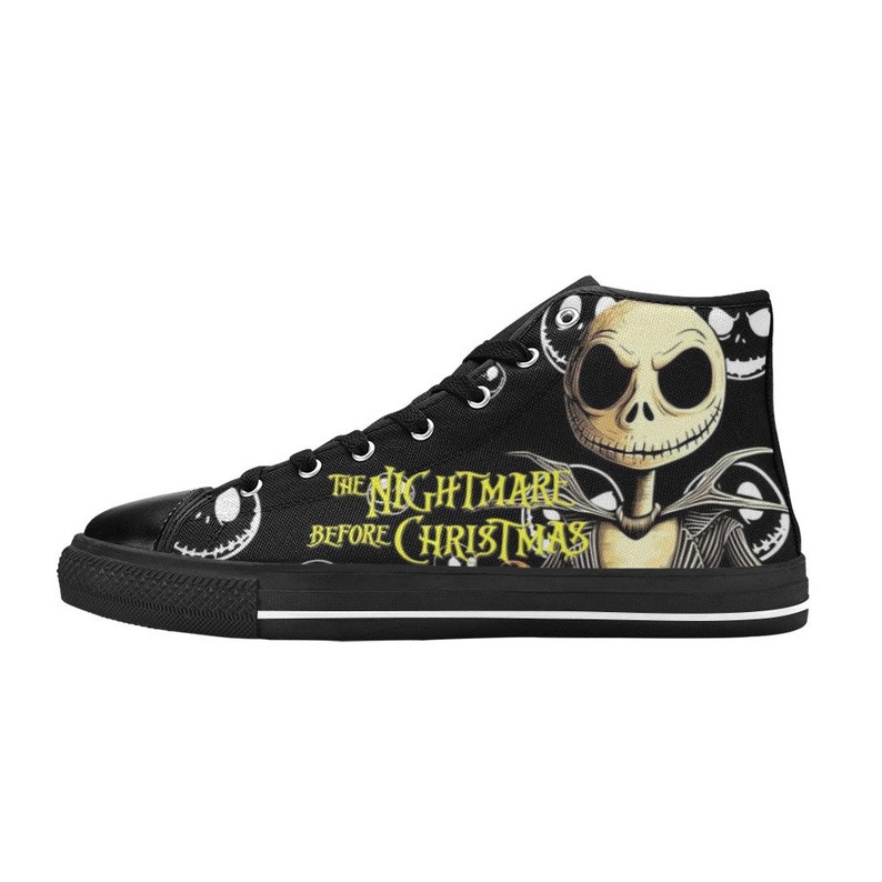 May include: Black high-top canvas sneakers featuring a design from "The Nightmare Before Christmas." The sneakers display Jack Skellington's face and the movie title in yellow. The shoes have white laces and a white sole.