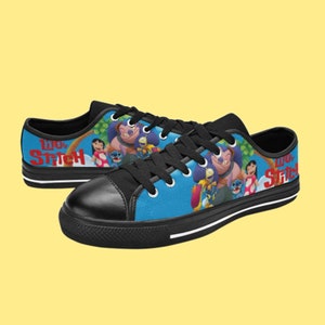 May include: Black canvas low-top sneakers with a blue background featuring Lilo and Stitch characters. The text "Lilo & Stitch" is printed in red on the side of the shoes.