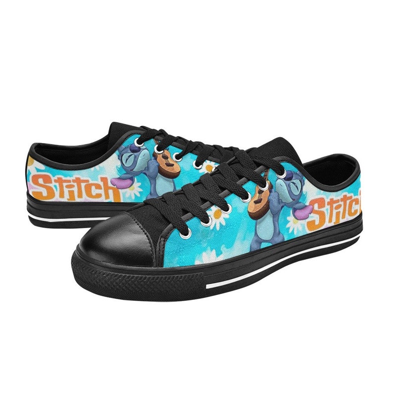 May include: Black canvas low-top sneakers with a blue and white print featuring Stitch from Lilo & Stitch playing a ukulele. The print also includes white daisies and the word "Stitch" in orange.