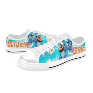 May include: White canvas low-top sneakers with a blue and white floral pattern featuring Stitch from Lilo & Stitch playing a ukulele. The words "Stitch" are printed on the side of the shoes.