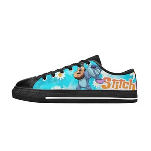May include: Black canvas low-top sneakers with a blue, white, and yellow design featuring Stitch from Lilo & Stitch playing a ukulele. The text "Stitch" is printed on the side of the shoe.