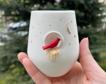 White, translucent coffee mugs with a handmade red bird figures, food-grade glaze and gold coloring