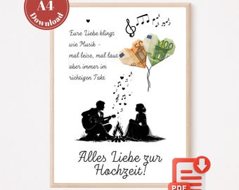 May include: A framed print with a romantic theme. The image features a couple silhouetted near a campfire, with musical notes and heart-shaped balloons made of Euro banknotes. Text in German reads "Alles Liebe zur Hochzeit!" and "Eure Liebe klingt wie Musik".